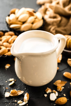 Homemade almond milk in jug. Almond milk and almonds