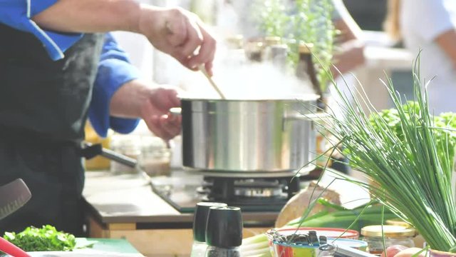 Chefs at work in a restaurant kitchen making delicious food