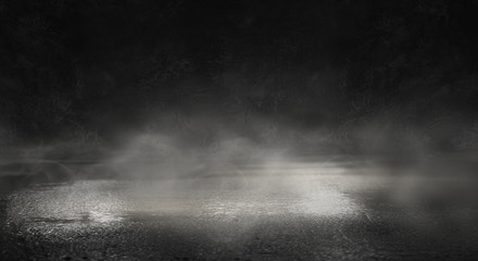 Background of an empty dark street, wet asphalt.