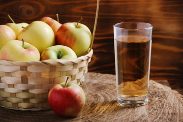 Apple cider in glass on wood background