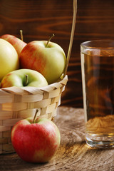 basket full of apple and glass with autumn drink