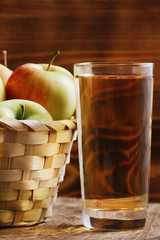 Apple cider in glass on wood background