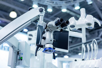 Dental microscope on the background of modern dentistry. Medical equipment. Dental operating microscope with rotary double binocular.