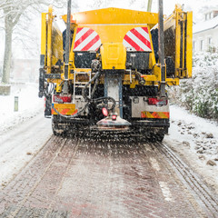 Winter road maintenance truck spreading salt