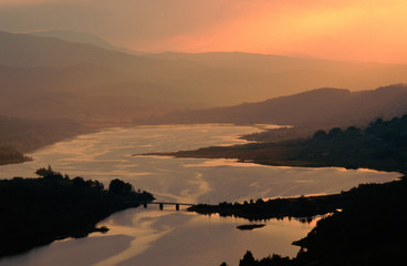 A map of Scotland appears at sunset on Loch Garry