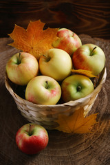apple in basket on background wood and dark low key
