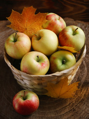 apple in basket on wood background