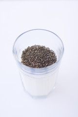 Chia seeds are drunk with airan from a glass.