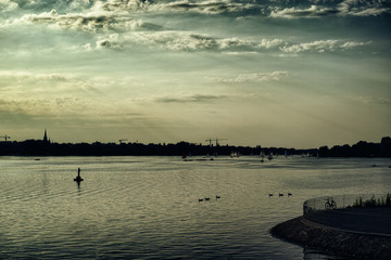 Alster Lake in Hamburg Germany View at beautiful and famous city park people rowing sailing panorama sky