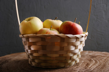 apple in basket on background wood and dark low key