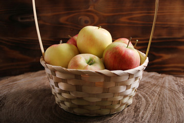 apple in basket on background wood and dark low key