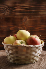 apple in basket on wood background