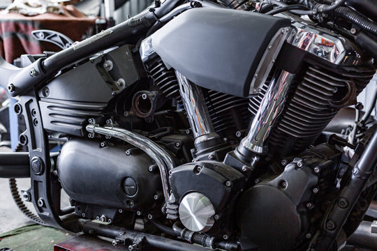 Cropped close up shot of beautiful and custom made motorcycle in the workshop