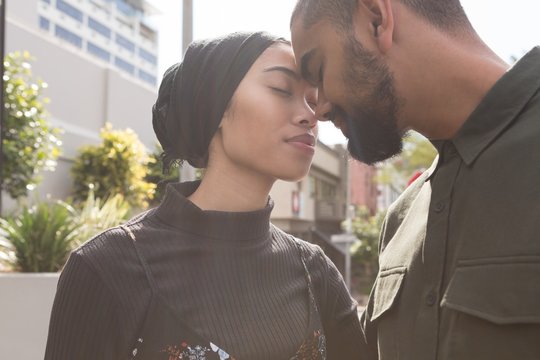 Couple romancing in city street