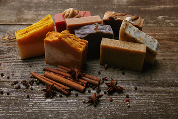 close-up shot of homemade soap pieces with spices on rustic wooden tabletop