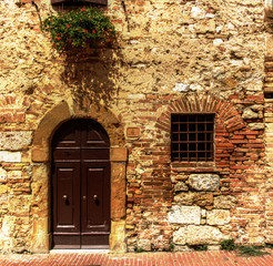 Fototapeta na wymiar Brick wall and doorway, Siena, Tuscany
