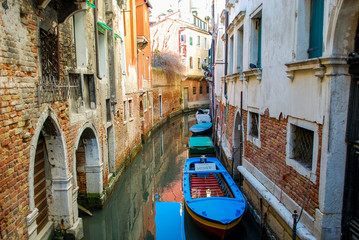 Fototapeta na wymiar Line of boats in a Venice Neighborhood Canal