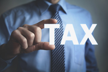 Businessman showing Tax word. Business concept