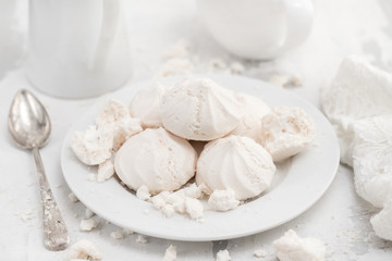 Fototapeta na wymiar merengues on white plate on white background