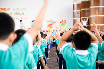 Asian kid stand in the line and exercise at outdoor. kid physical activity in school.