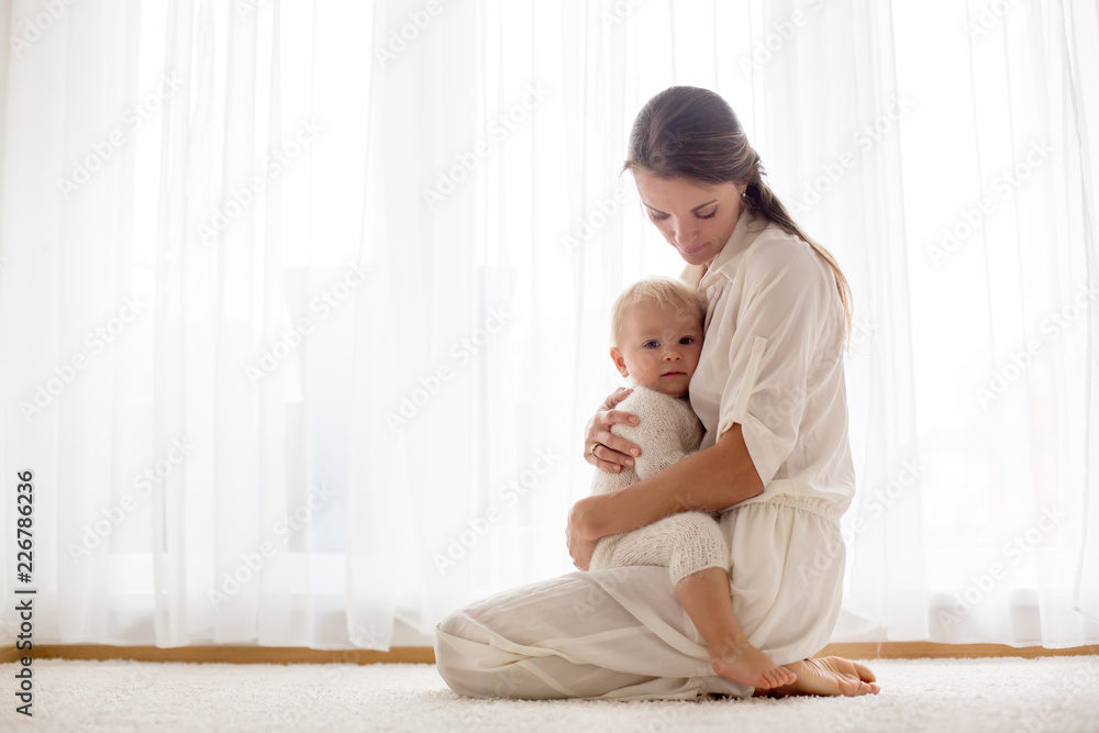 Canvas Prints Young mother breastfeeding her toddler baby boy .