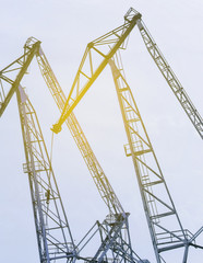 Fototapeta na wymiar Lifting cranes inversion. Loading and construction.