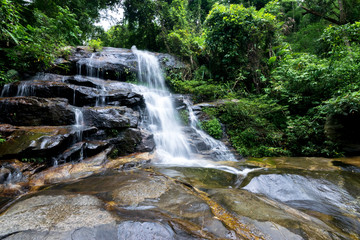 Obraz premium Monthathan Waterfall, a natural destination tourism place on the way Doi Suthep temple in Chiang Mai, Thailand