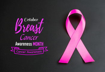 Pink ribbon on black background  for supporting breast cancer awareness month campaign.