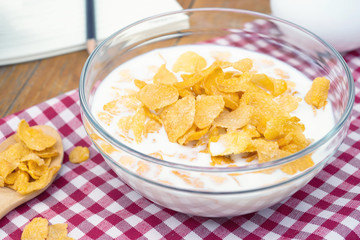 Cornflakes cereal and milk in a bowl. Morning breakfast.