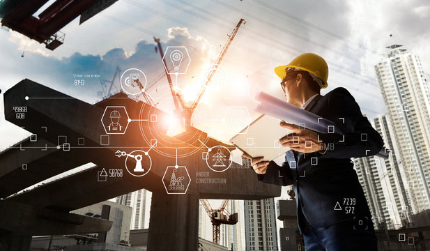 A futuristic architect, Businessman on Industry 4.0. Engineer manager using tablet with icon network connection in construction site, Industrial and innovation. Industry technology concept.