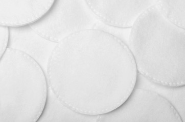 A pile of cotton pads for personal care. Careful make-up removal. Beauty and health. Top view, flat...