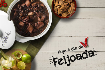 Brazilian Feijoada Food. Written "Today is Feijoada's Day" in Portuguese. Top view with copy space.