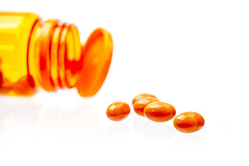 Vitamin Rice Bran Oil , Orange pills on white background.