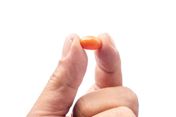 Vitamin Rice Bran Oil , Orange pills on hand.