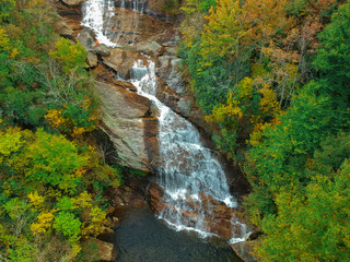 Aerial drone view of Autumn / Fall foliage of River and Waterfall in the Blue Ridge Mountains of Asheville, North Carolina. 