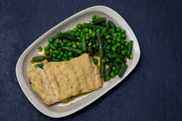 cod fish with green beans and peas on dish