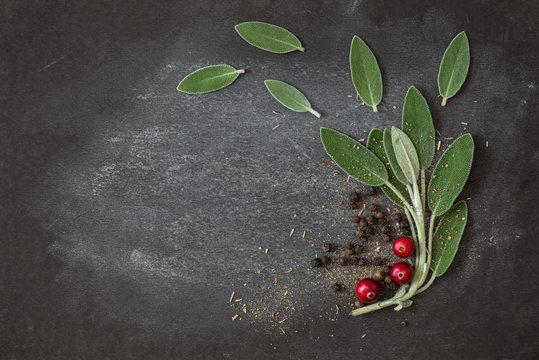 Leaves of fresh sage, black ceg peas on a dark background