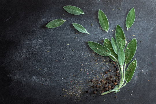 Leaves of fresh sage, black ceg peas on a dark background