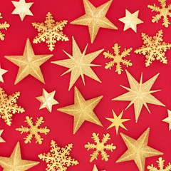 Gold glitter star Christmas abstract background on red. Traditional Christmas greeting card for the festive season.