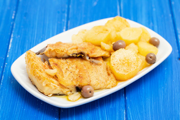 cod fish with fried potato on white dish