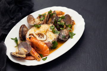 boiled fish with seafood on dish