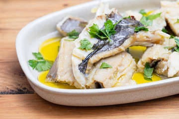 boiled cod fish with herbs and olive oil