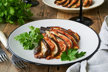 Baked eggplants with tomatoes, garlic and cheese on a plate