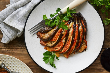 Baked eggplants with tomatoes, garlic and cheese on a plate