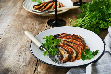 Baked eggplants with tomatoes, garlic and cheese on a plate