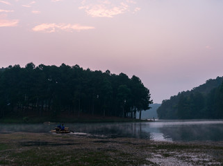 Morning mist twilight before sunrise on a calm tropical mountain lake in Pang Ung , Mae Hong Son province,Thailand