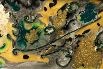 Green marble abstract acrylic background. Marbling artwork texture. Agate ripple pattern. Gold powder.