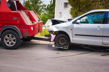Crashed car after accident ready to be tow away by tow truck