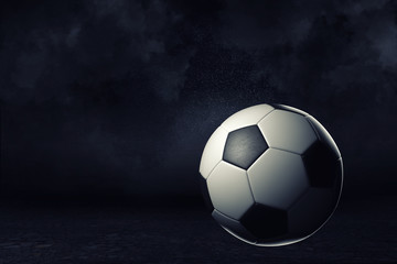 3d rendering of a single football ball on a dark background under bright spotlight.