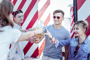Best friends. Pleased girl standing in semi position and spending time with her best friends
